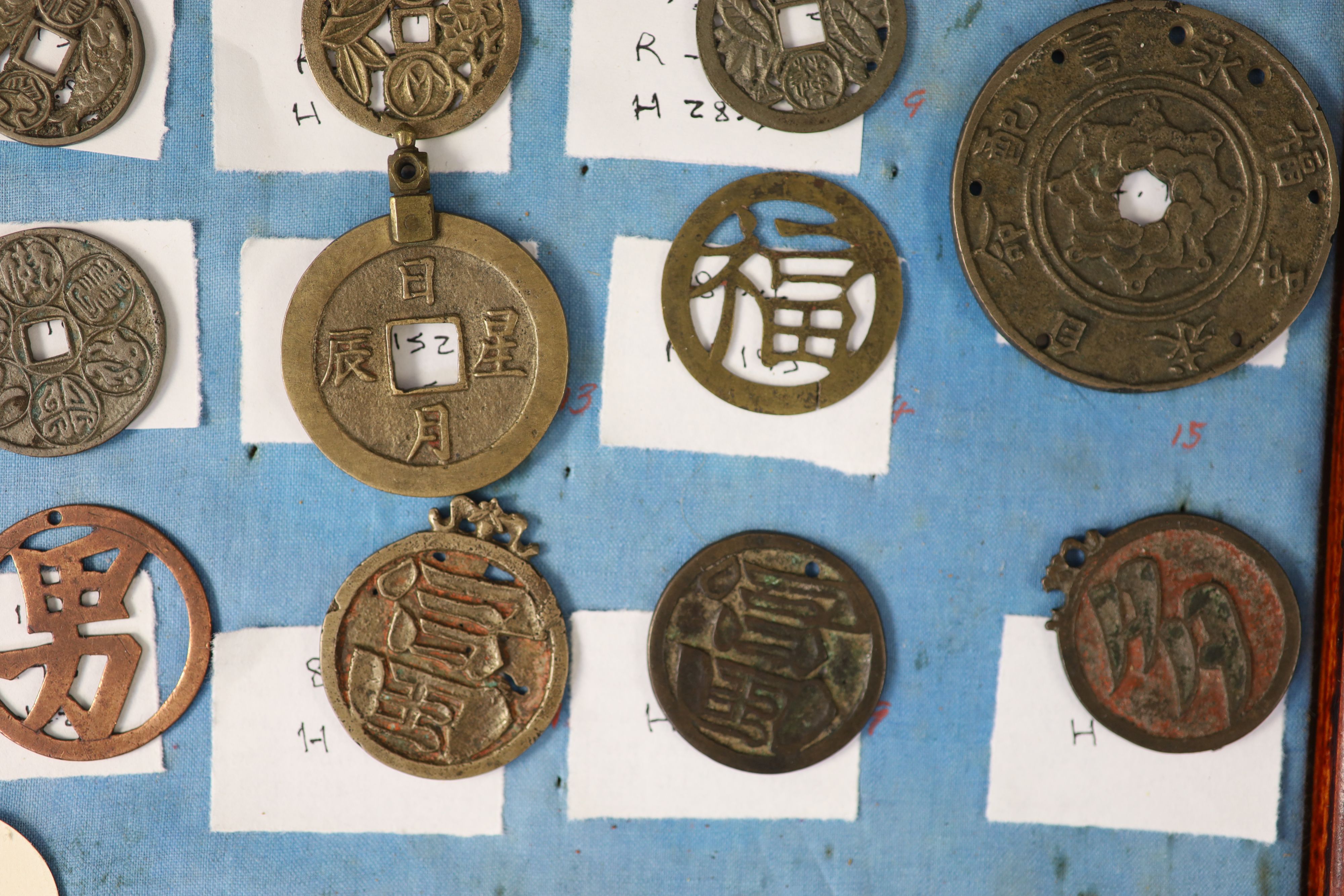 A group of 99 Korean bronze and metal amulets or charms, 19th/20th century